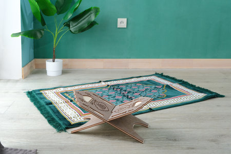 peaceful minimalist prayer space with prayer rug and wooden book stand in the room