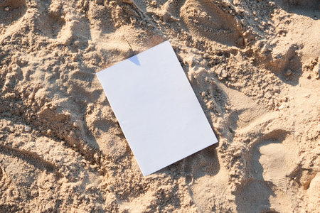 blank magazine mockup on sandy beachの写真素材