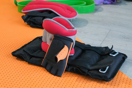 fitness weights, fitness equipment or interior on floor at home. Empty room or space with fitness...