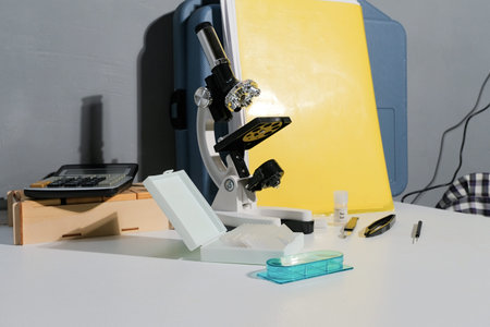 Small microscope for children on the desk, homework at home, education and exploration for kids
