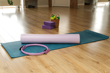Yoga accessories in gym or sport studio, yoga block, pilates ring, massage balls and a mat with copy spaceの写真素材