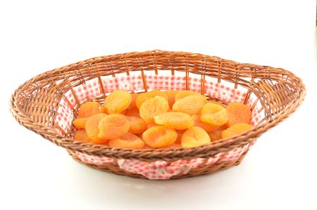 Dried apricots in a basket made of wicker の写真素材
