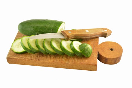 Cucumbers sliced whole knife in wood on a wooden boardの写真素材