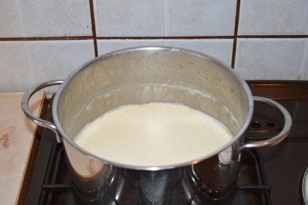 Milk in a saucepan on the stoveの写真素材