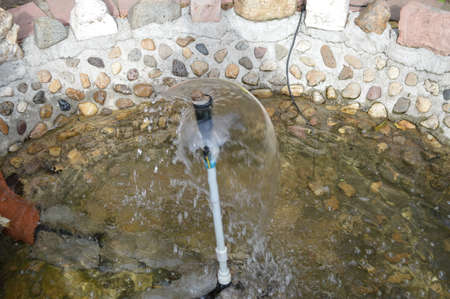 The snail climbed the fountain pillar and enjoyed the water.の写真素材