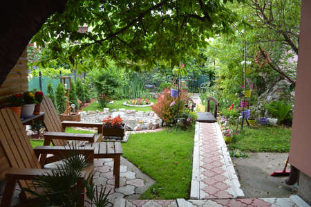 Serbian house garden, smooth green grass lawn, colorful flowering plant, in good care maintenance landscaped in the park stock photoの写真素材