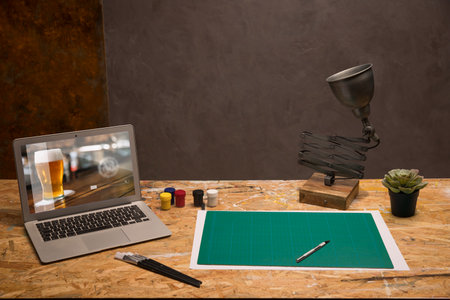 Mockup image of graphic designer workspace with laptop computer and sketches.の写真素材