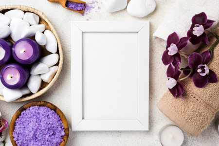Spa still life with white frame, sea salt, candles and orchid flowers on white backgroundの写真素材