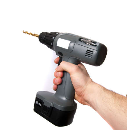 A hand using a gray drill isolated on whiteの写真素材