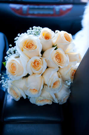 Yellow wedding bouquet in car.の写真素材
