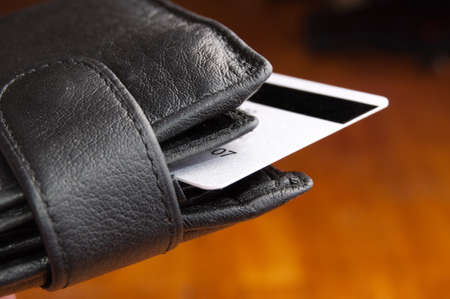 Black leather wallet on a Brown backgroundの写真素材