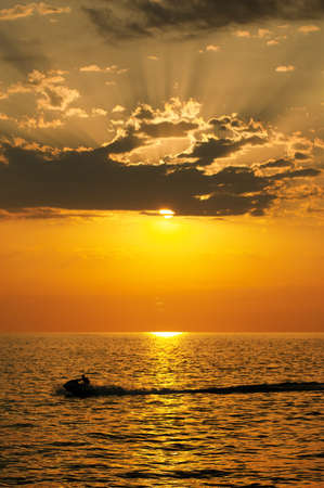 Jetski in beautiful sea at sunsetの写真素材
