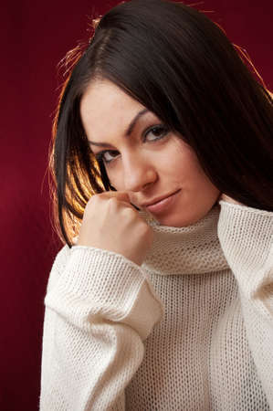The portrait of beautiful woman on red backgroundの写真素材