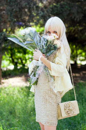 portrait of beautiful girl with two bouquetsの写真素材