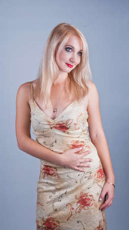 portrait of a beautiful dreaming lady in beige dresの写真素材