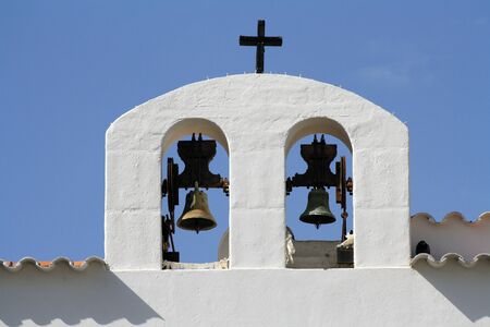Two bells of a white church in Ibiza, Spain