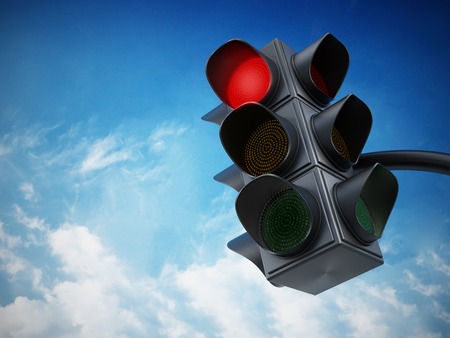 Green traffic light against blue sky.