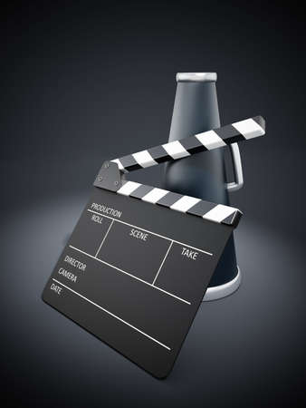 Clapboard and bullhorn on black spotlit backgroundの写真素材
