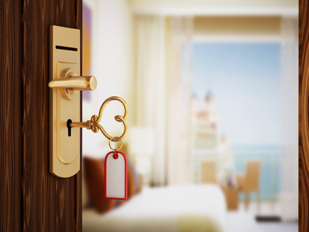 Heart shaped hotel room key on the doorの写真素材