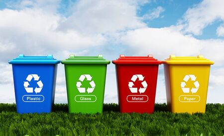 Plastic, glass, metal and paper recycle bins standing on green grass.の写真素材
