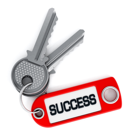 Key attached to success label isolated on white backgroundの写真素材