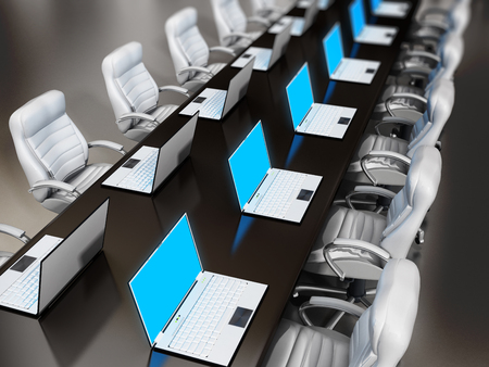 Laptop computers standing on wooden boardroom table
