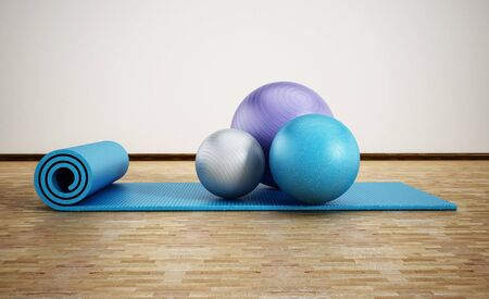 Pilates mat and exercise balls standing on parquet floor. 3D illustration.の写真素材