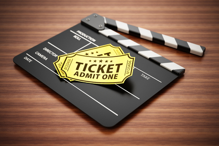 Clapboard and cinema tickets standing on wooden surface. 3D illustration.の写真素材