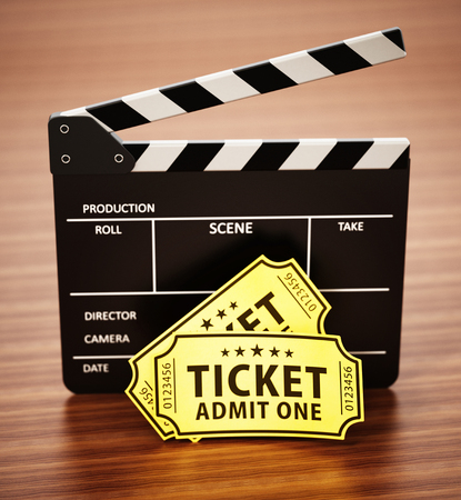 Clapboard and cinema tickets standing on wooden surface. 3D illustration.の写真素材