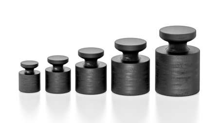 Vintage black balanced scale wights isolated on white background.の写真素材