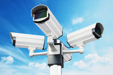 Security cameras on the pole on blue sky background. 3D illustration.