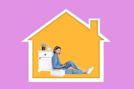 Happy asia girl enjoy life at home with purple background.の写真素材