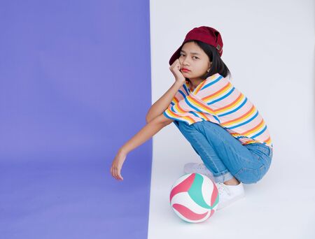 Happy young asian girl with volleyball and pastel background.の写真素材
