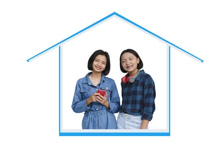 Two happy young asian girls enjoy time at home with white background.の写真素材