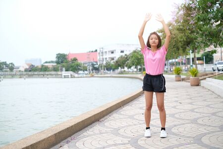 Young Asian girl exercise at health park.の写真素材