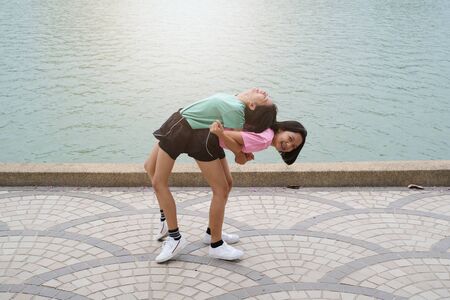 Young Asian girl exercise at health park.の写真素材