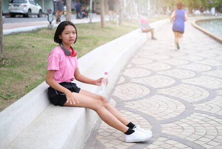 Young Asian girl exercise at health park.の写真素材