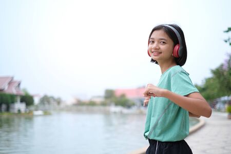 Young Asian girl exercise at health park.の写真素材