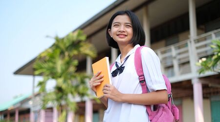 Happy young asian girl wear unifrom at school.の写真素材