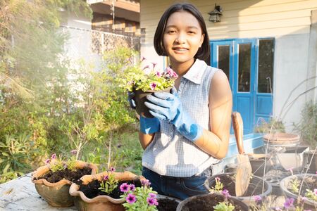 Planting a flower. Young working in the garden at home.の写真素材