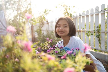 Planting a flower. Young working in the garden at home.