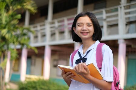 Happy young asian girl wear unifrom at school.の写真素材