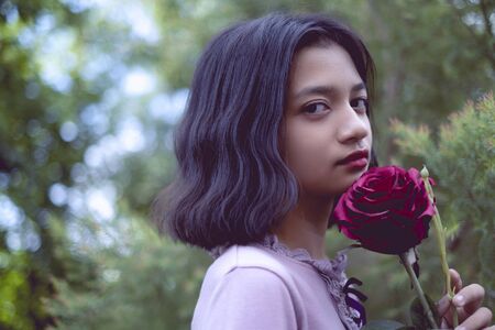 Portraits lonely young girl with pine tree background in vintage color.の写真素材