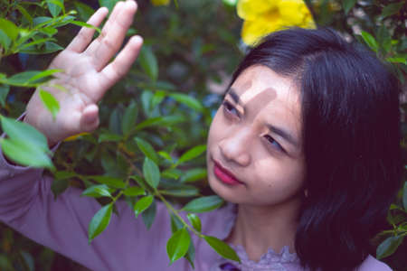 Portraits smiling Asian young girl with pine tree in vintage color.