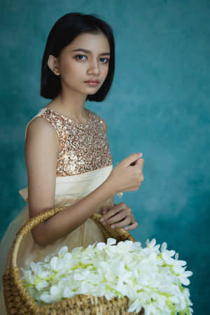 Portrait beautiful young girl with flower and green retro background.の写真素材