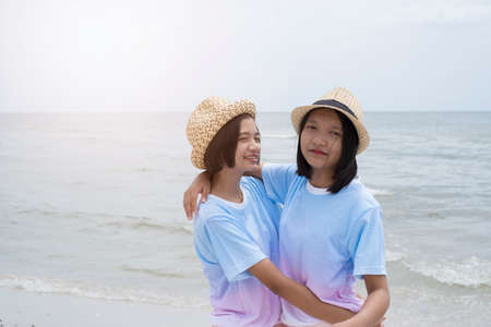 Two young girl having fun at beautiful beach.