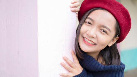 Headshort portrait happy young girl wear sweater and red hat.の写真素材
