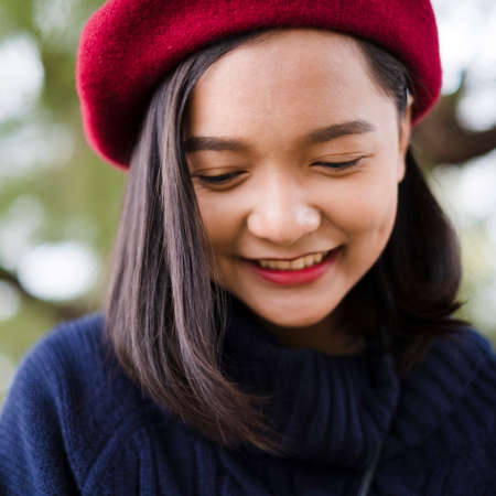 Portrait smile young girl in autumn on nature background.の写真素材