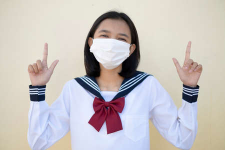 Asian student wear mask in school uniform.の写真素材