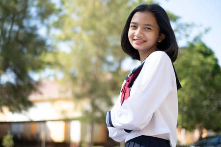 Smiling student  wear school uniform and standing at school.の写真素材
